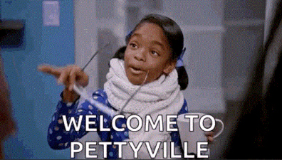 A young girl dramatically removes her glasses while saying, “Welcome to Pettyville,” a meme to accompany finance jokes involving “petty cash”.