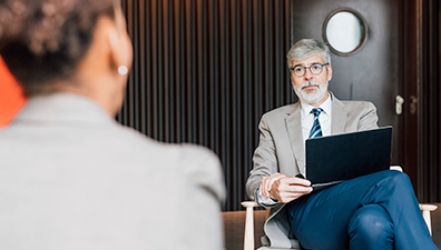Stock photo of a job interview. Used in finance jokes where “What’s your hedge?” is a pun on hedge funds or standing out as an advisor.